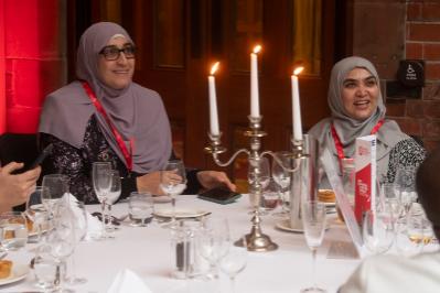 two ladies at a table with candles